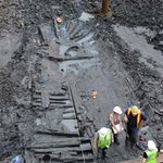 Archaeologists examine the hull